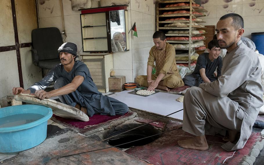 Zalmai Faqirzada, left, makes bread with his colleagues at a bakery close to Kabul's Green Zone on Sunday, May 2, 2021. Faqirzada said he feared violence would escalate in the city as foreign forces leave. 
