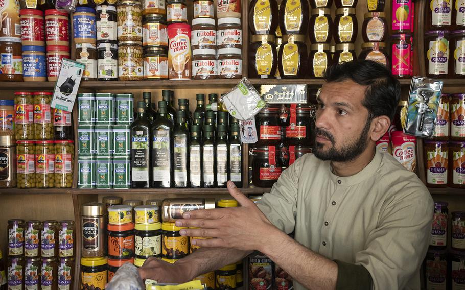 Grocer Talha Hairan on Sunday, May 2, 2021, explains how he and others in his Kabul neighborhood worry that violence will increase as foreign forces withdraw from Afghanistan. Hairan's shop is next to Kabul's Green Zone that houses NATO's Afghanistan headquarters. 