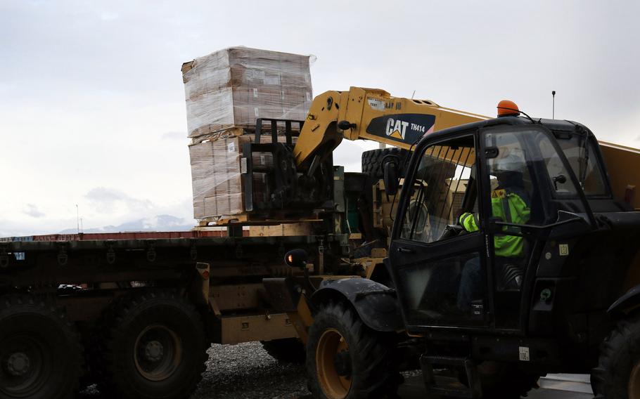 An employee of the Fluor Corporation loads Meals Ready-to-Eat cases at Bagram Airfield, Afghanistan, in 2017. Hundreds of foreign contractors at Bagram say Fluor is discriminating against them, and paying them less, because of their nationalities. 