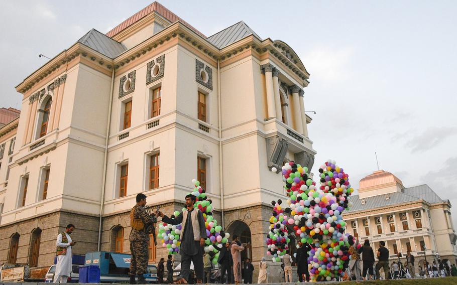 Workers at Darul Aman Palace prepare balloons for a celebration of Afghanistan’s Independence Day in Kabul on Aug. 18, 2020. The palace, once riddled with bullet holes and bomb craters, has been restored.

