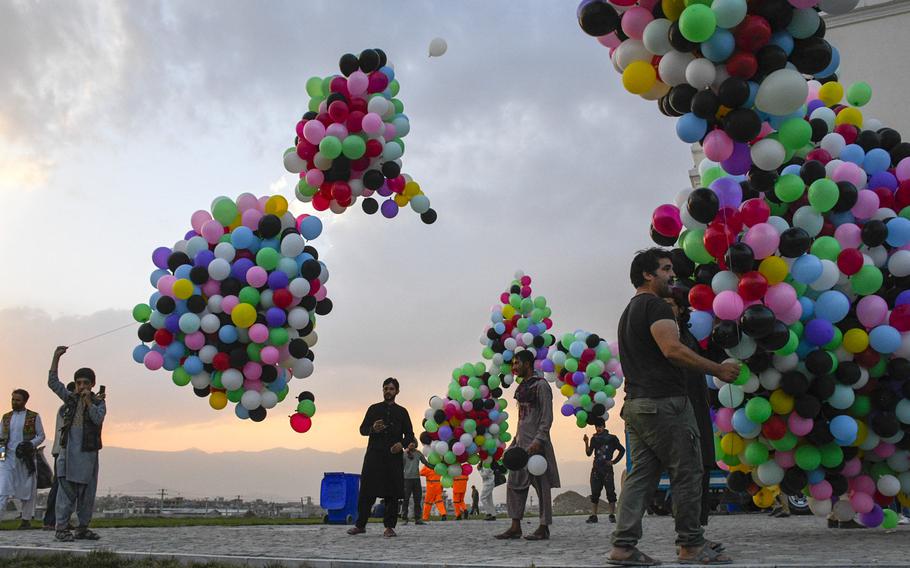 Workers at Darul Aman Palace prepare balloons for a celebration of Afghan Independence Day in Kabul on Aug. 18, 2020. The palace was restored last year.

