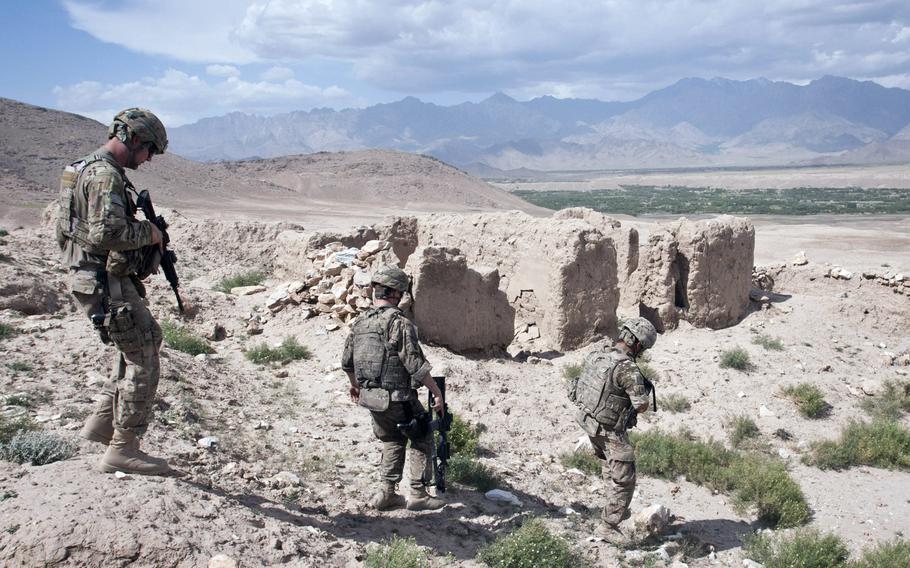 Airmen with the 455th Air Expeditionary Wing, Task Force Reaper, descend a hillside past an old earth building near Bagram Airfield in 2012.  Media reports indicate President Donald Trump will reduce the number of U.S. forces in Afghanistan to 2,500 by mid-January. 

