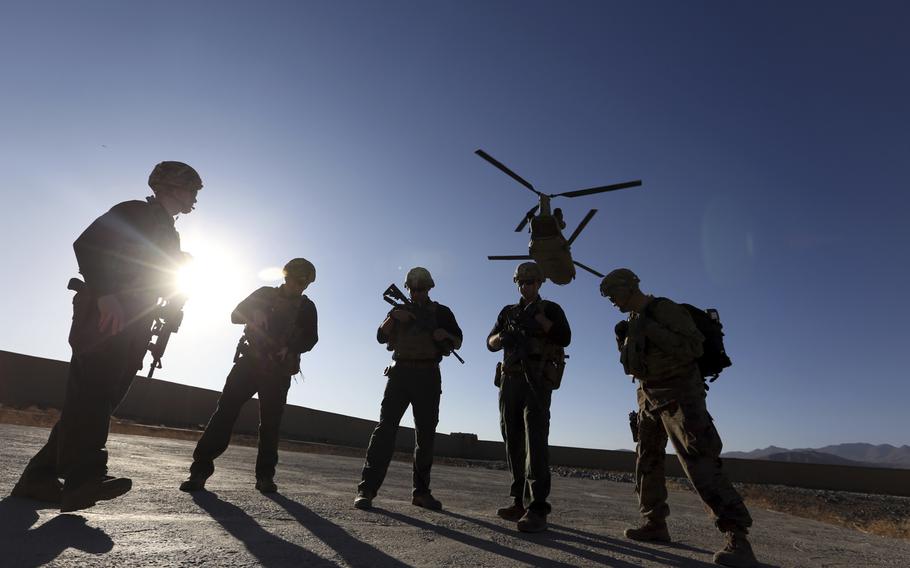 American soldiers wait on the tarmac in Logar province, Afghanistan, on Nov. 30, 2017.