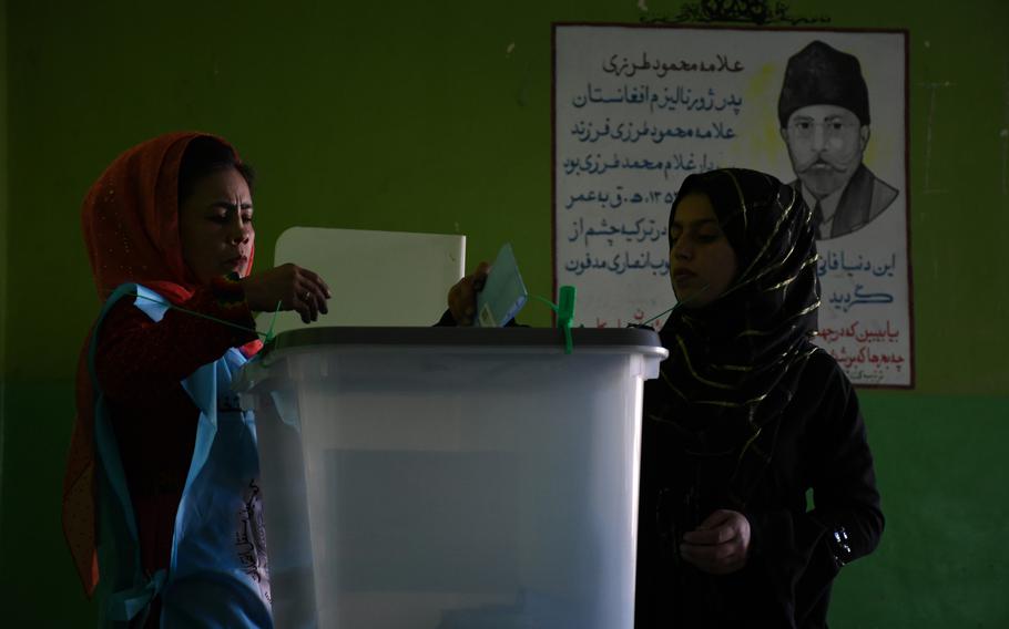A woman votes in Afghanistan's presidential election on Saturday, Sept. 28, 2019.