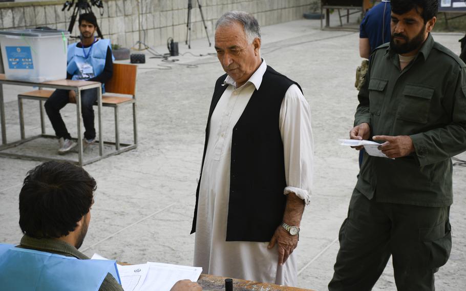 A voter prepares to vote in Afghanistan's presidential election at a polling station in downtown Kabul, Afghanistan, on Saturday, Sept. 28, 2019.