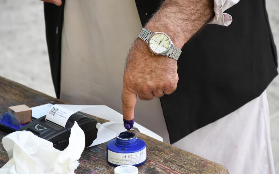 An Kabul resident dips his finger into ink to indicate he voted in Afghanistan's presidential election on Saturday, Sept. 28, 2019.