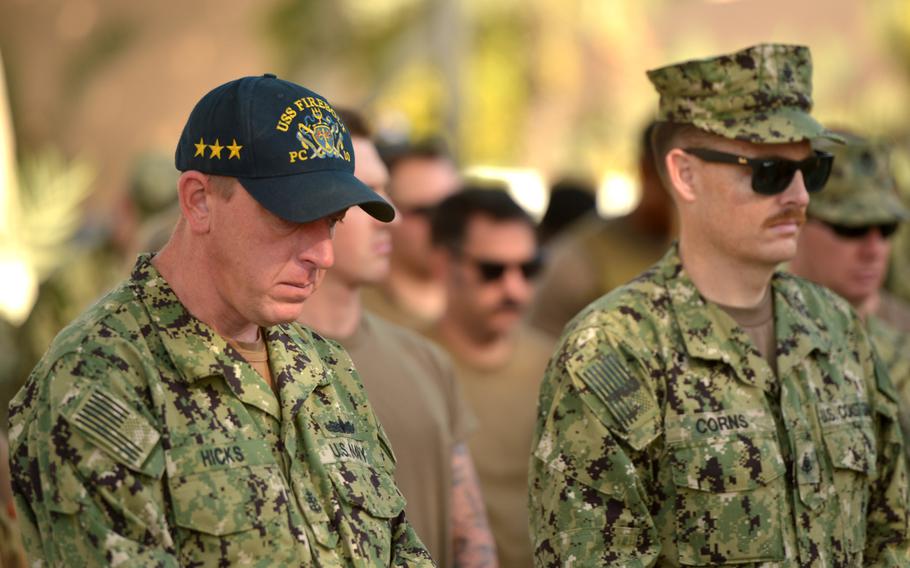 U.S. Navy sailors and Coast Guardsmen participate in a moment of silence during a memorial ceremony for the USS Firebolt at Naval Support Activity Bahrain on April 24, 2019. 

