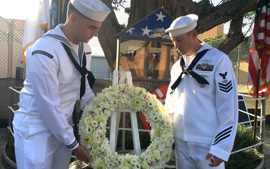 USS Firebolt sailors lay a wreath for the crewmembers of the ship who died in a 2004 suicide attack, during a memorial ceremony at Naval Support Activity Bahrain on April 24, 2019. 

