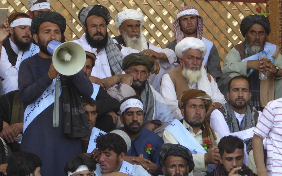 Iqbal Khayber, an organizer of a peace march from Helmand province to the Afghan capital, speaks through a bullhorn at a gathering of the marchers in Kabul in June 2018. Peace activists who marched unarmed into hostile territory to talk to the Taliban in May said that while rank-and-file militants seemed keen for peace, their commanders insisted a political solution can only come from above. 