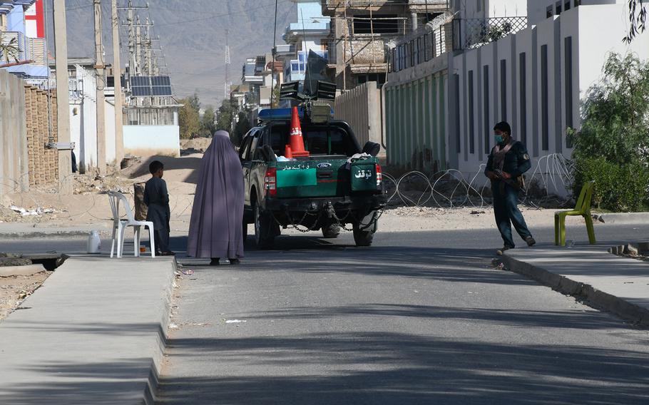 A woman walks down a street in Kandahar, Afghanistan, on Oct. 27, 2018. An attack in the city in July killed seven civilians and wounded more than 70 others, according to the United Nations. 