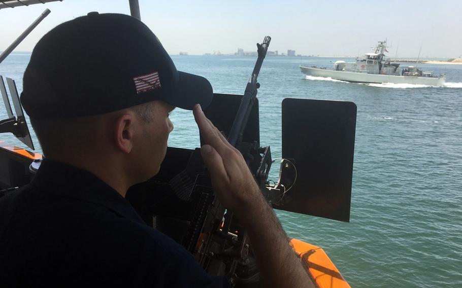 Coastal patrol ship captain Lt. Cmdr. Dale Tourtelotte, from the USS Hurricane, salutes a passing Bahraini patrol ship while underway on June 30, 2019. Ten coastal patrol ships, or PCs, operate in the Persian Gulf and are homeported at Naval Support Activity Bahrain.

