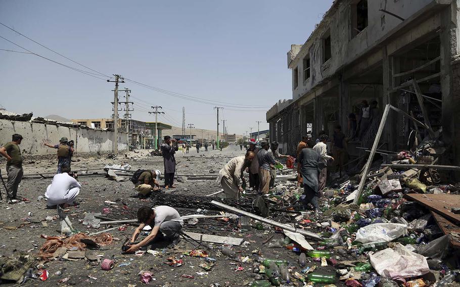 Journalists record the scene at the site of a suicide attack in Kabul, Afghanistan, Thursday, July 25, 2019. 