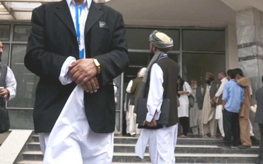 Delegates file out of a building at the Kabul Polytechnic University following the second day of a peace jirga aimed at ending the war in Afghanistan. Officials say the three-day conference is only the beginning of what is likely to be a long process but hope the participation of a broad range of Afghans will jump-start negotiations that made little headway to date.
