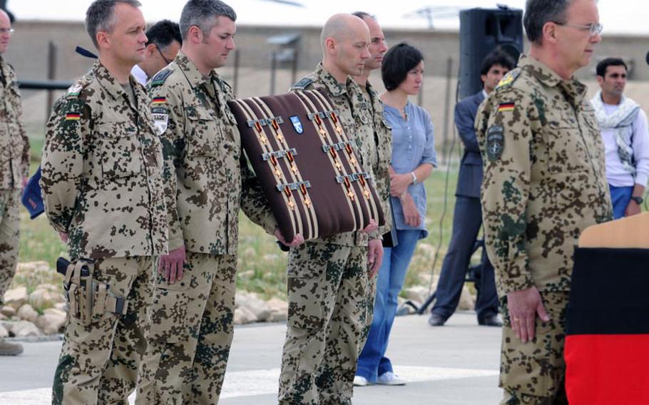 ISAF Chief of Staff German Army Lt. Gen. Bruno Kasdorf stands at attention during a moment of silence before presenting his country&#39;s Gold Cross  medal to pilots and crew members of 5th Battalion, 158th Aviation Regiment on May 12 in Kunduz, Afghanistan.