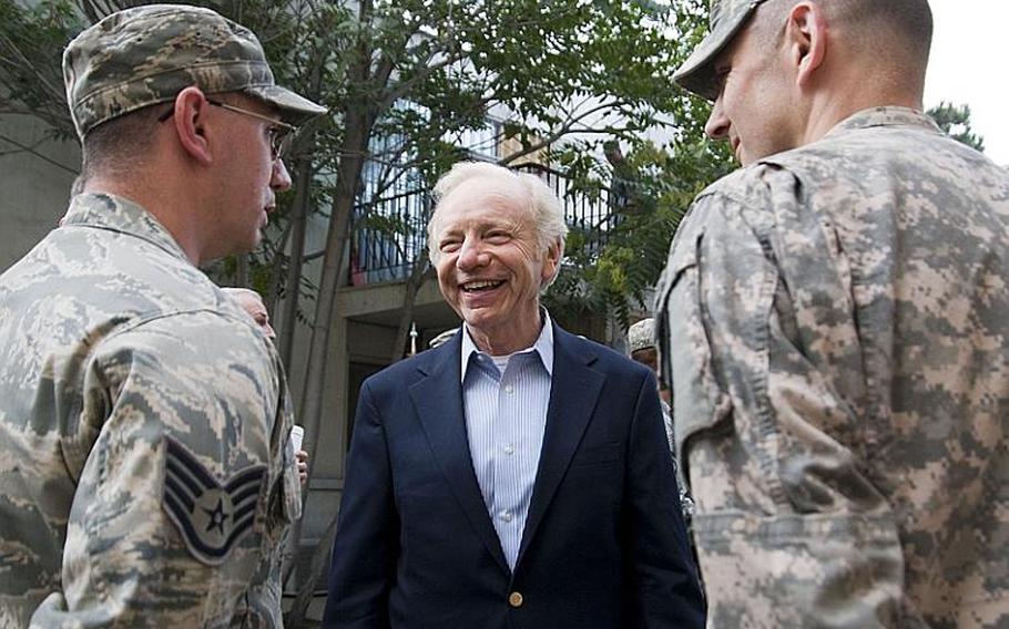 Sen. Joe Lieberman talks to several constituents during a visit to Camp Eggers in Kabul on Sunday. He and Sens. John McCain and  Lindsey Graham helped present several combat infantry badges.