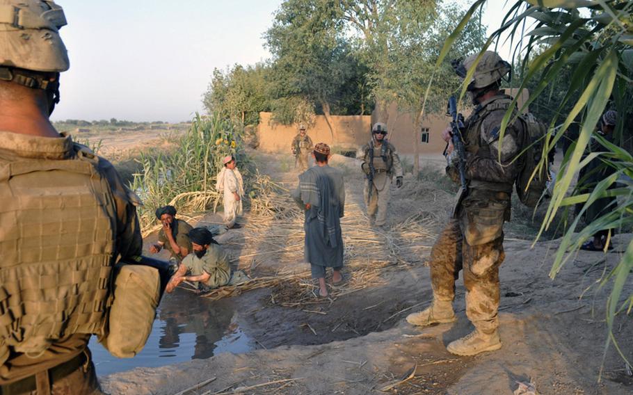 Marines, here on patrol in Marjah District on June 19, must mix their efforts at empowering the population with their fight against the insurgents who blend in.