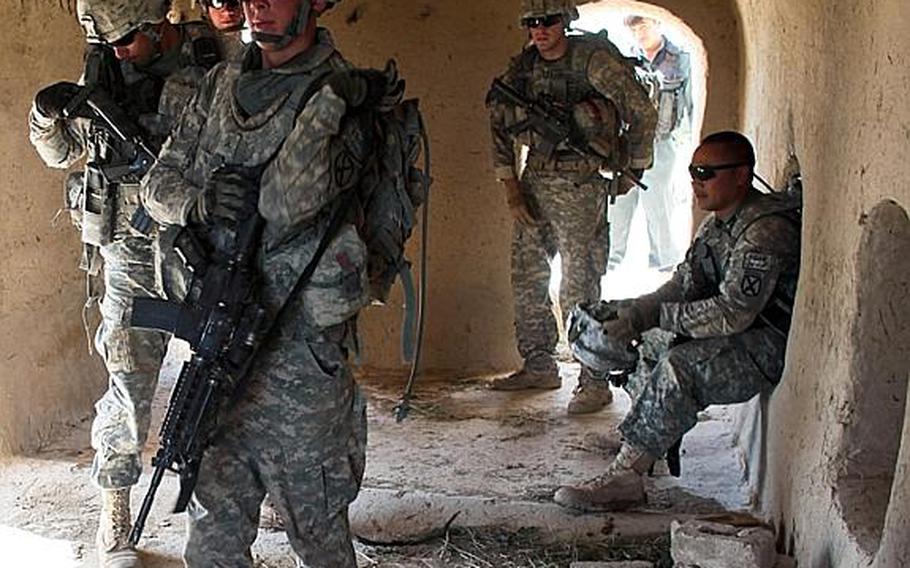 Soldiers from Troop B, 1st Squadron, 71st Cavalry Regiment prepare to move out on patrol after a quick break from the 110 degree heat in Dand district, Kandahar province, Afghanistan. June 19, 2010.