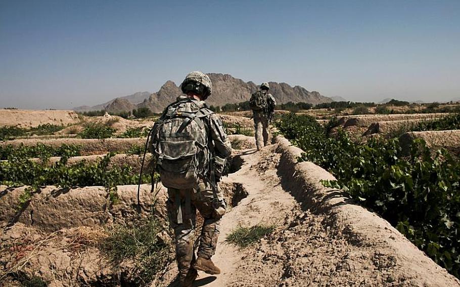 Soldiers from Troop B, 1st Squadron, 71st Cavalry Regiment,  patrol through a grape orchard in Dand district, Kandahar province, Afghanistan. June 19, 2010.