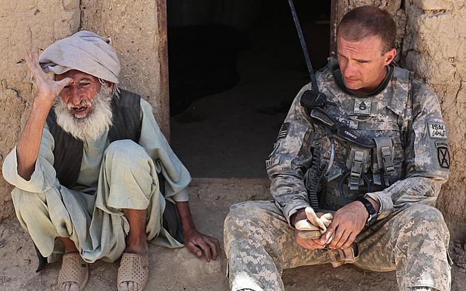 Staff Sgt. Richard Balch, of Troop B, 1st Squadron, 71st Cavalry Regiment, listens as an old man in Dand district, Kandahar province, Afghanistan describes the hardships he has faced during the last 30 years of fighting. "I don&#39;t need any help from anyone," the old man said. "It will only cause me problems."  June 19, 2010.