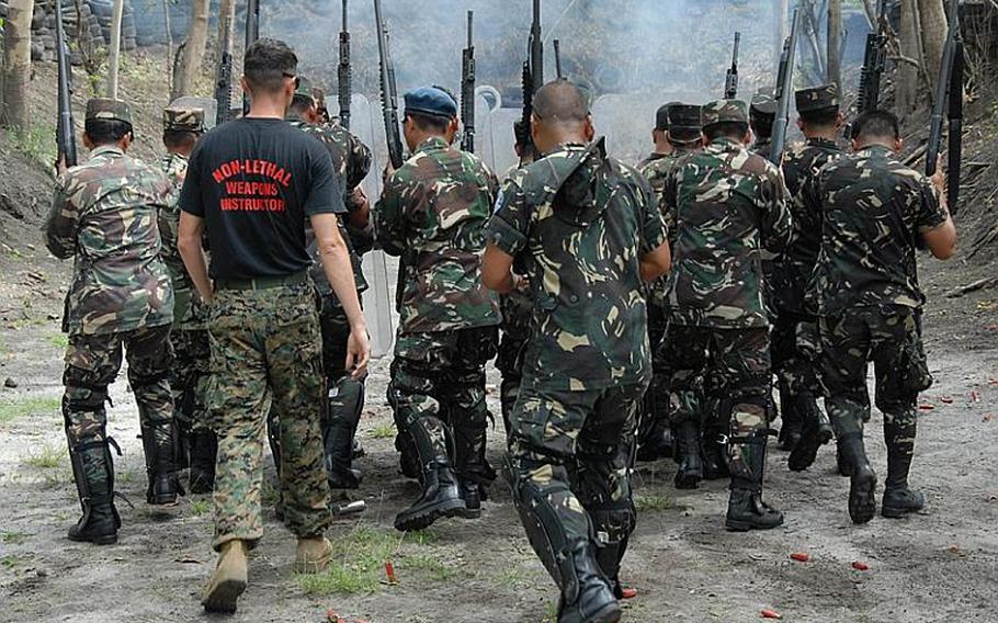 Okinawa-based U.S. Marines with the 3rd Marine Expeditionary Force's Special Operations Training Group instruct Filipino troops in the use of nonlethal weapons during the 2009 Balikatan training exercise Friday on what was once the U.S. Air Force's Clark Air Base.
