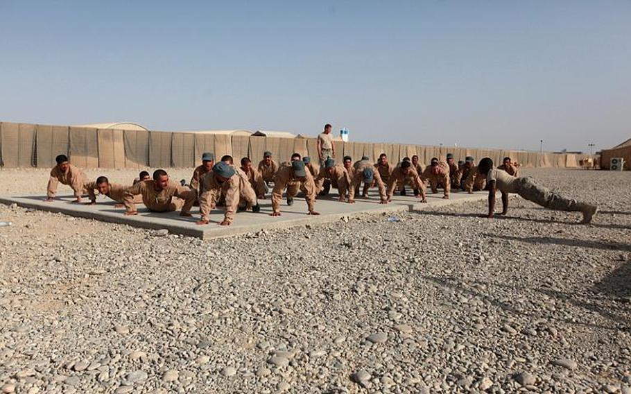 Afghan police recruits are given instruction by U.S. forces and Afghan linguists at the Joint Security Academy Southwest at Camp Leatherneck in Helmand province, Afghanistan, on June 28.