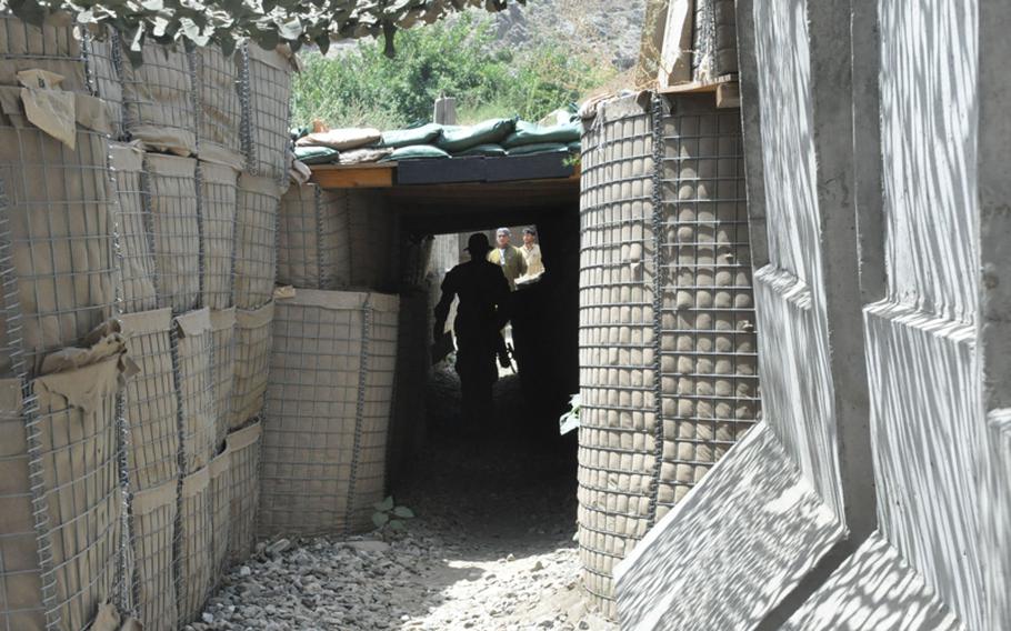 A soldier walks through a protected maze of tunnels at COP Michigan on July 19. The outpost takes fire regularly from the mountainsides.