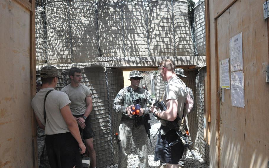 Soldiers talk on July 19 in a protected maze of tunnels in the frequently attacked Combat Outpost Michigan in the Pech River Valley of Kunar province.