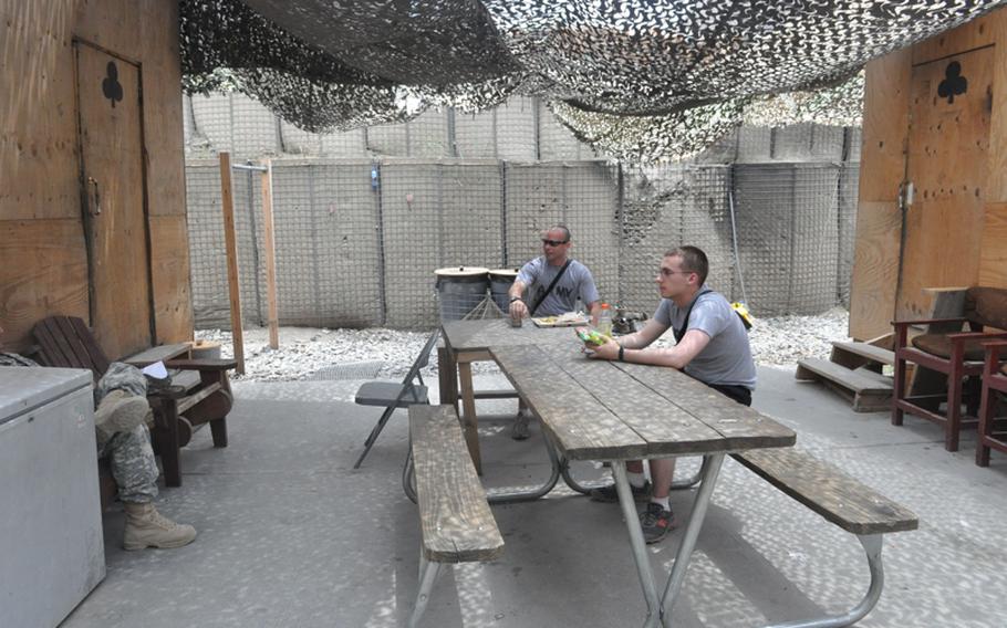Soldiers relax on July 19 at the only outdoor seating area in a protected maze of tunnels in the frequently attacked COP Michigan in the Pech River Valley in Kunar province.