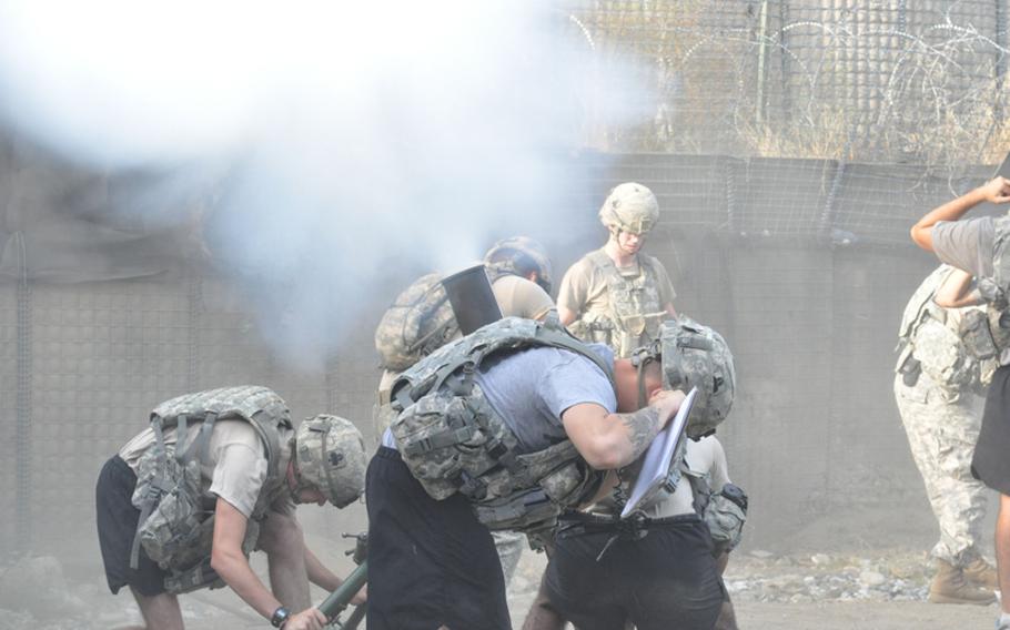 Mortarmen fire off rounds at Combat Outpost Michigan in the Pech River Valley on July 19. The base is frequently attacked from the mountains above.