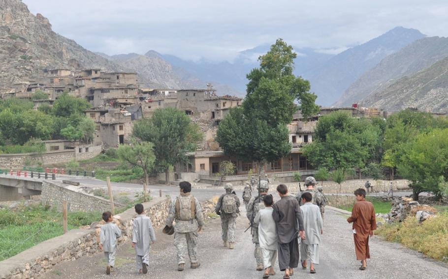 Children from Kandagal village follow Afghan and U.S. soldiers to the bank of the Pech River on July 21, as the soldiers return to their base on the opposite side of the river.