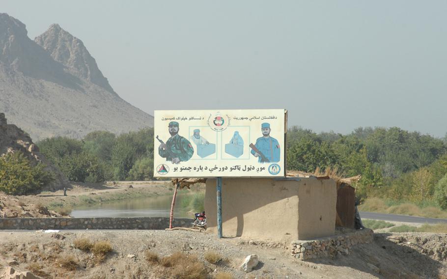 A billboard in Kandahar province depicts voters casting ballots under the protection of the Afghan police and army. Parliamentary elections are scheduled nationwide on Sept. 18.