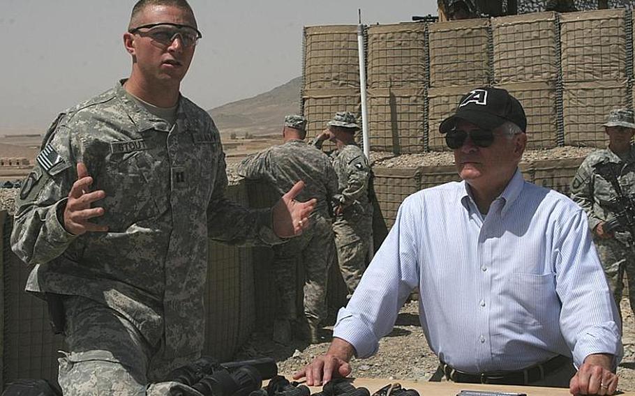 Defense Secretary Robert Gates looks into Taliban terrority, just 50 yards from atop Combat Outpost Senjaray in Kandahar province, Afghanistan, on Friday.
