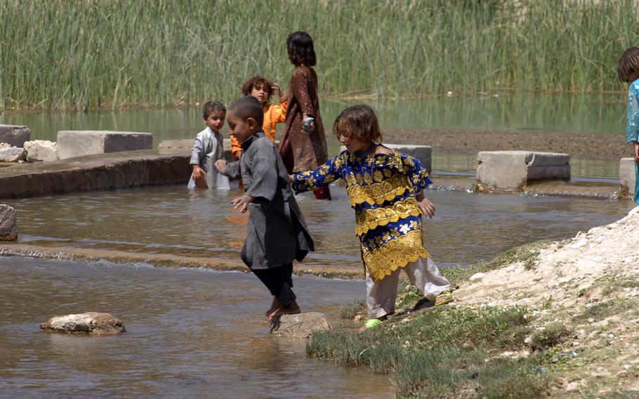 Children play in one of the many streams flowing through Helal China, an isolated village in Zabul province's Shah Joy district.