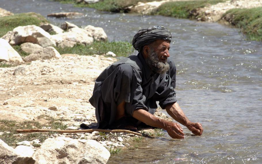 A man cools off in one of the many streams flowing through Helal China, an isolated village in Zabul province's Shah Joy district.