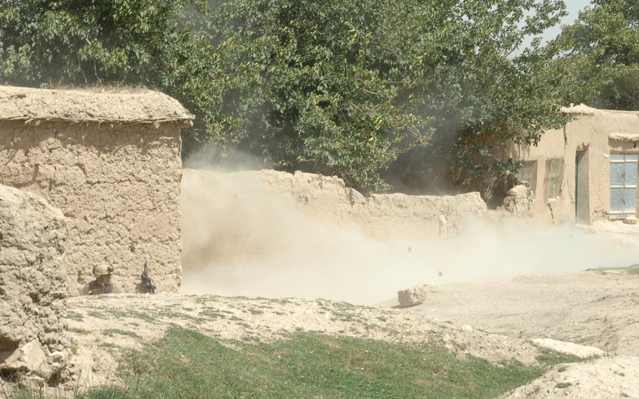 A Navy Explosive Ordinance Disposal expert, lower left, takes cover during a recent controlled denotation to remove an improvised explosive device in Helal China, Zabul province, Afghanistan.