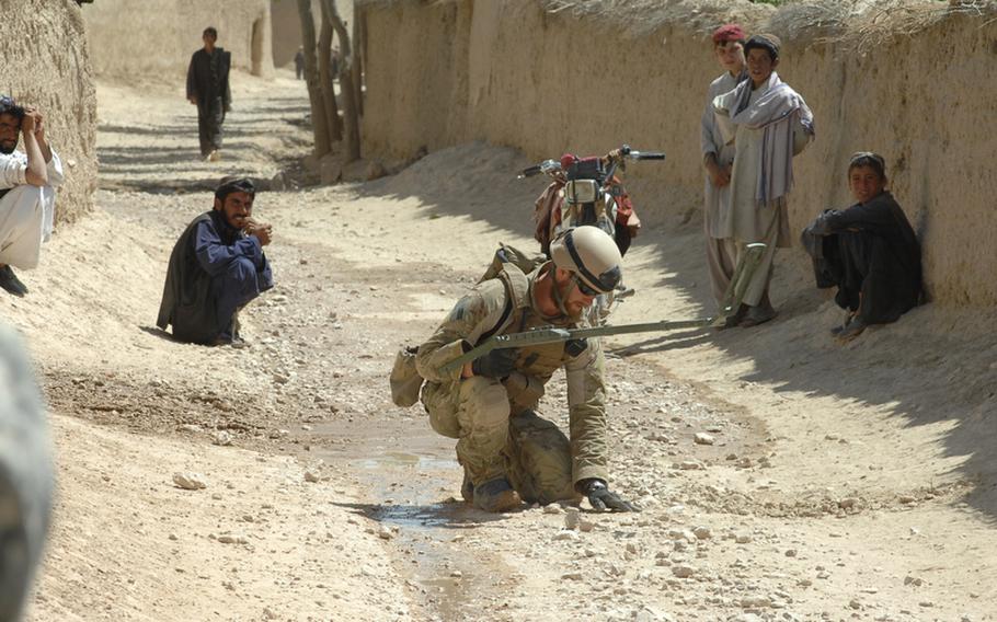 Navy Construction Mechanic Mikel Irvine, 26, of Tucson, Ariz., searches for a bomb during a counter-IED operation in Helal China, Zabul province, Afghanistan recently.