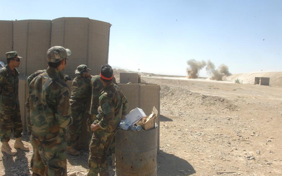 A group of Afghan commandos watches an explosion during counter-IED training at Kandahar Air Field on Sunday, Sept. 26.