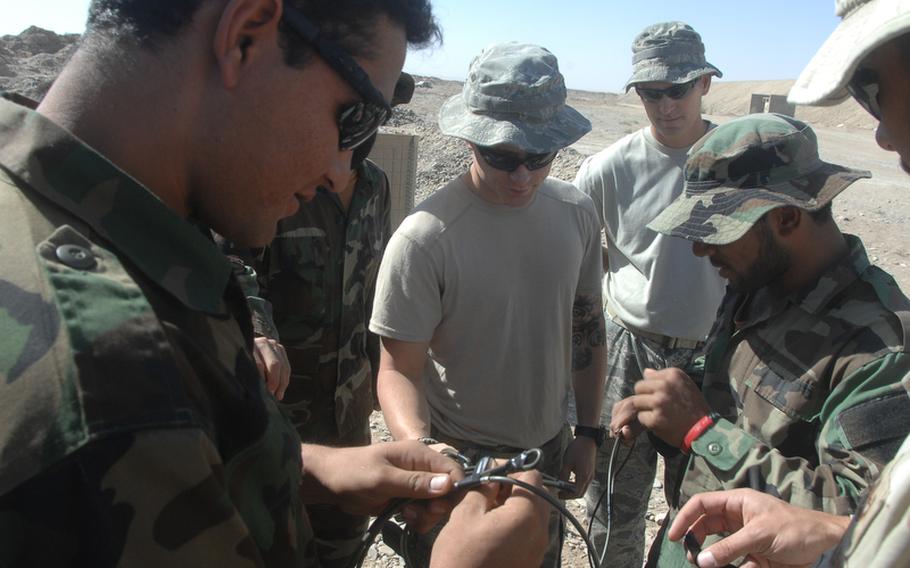 U.S. personnel train Afghan commandos to defeat improvised explosive devices at Kandahar Air Field on Sunday, Sept. 26.