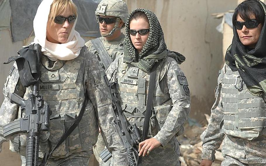 Female Engagement Team member Pfc. Rachel Miller, 39, of Northumberland, Pa., civil affairs soldier Cpl. George Brady, 33, of Miami, and Female Engagement Team members Pfc. Kelly Shutka, 22, of Pine Glen, Pa., and Laila Khoshnaw patrol through a bazaar in Zabul province, Afghanistan.