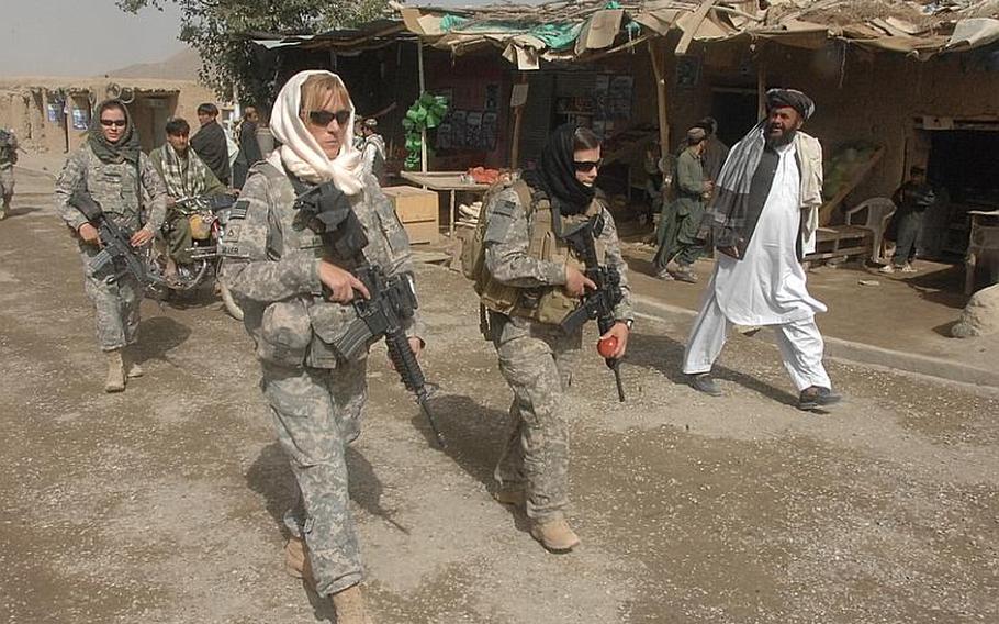 Female Engagement Team members Pfc. Kelly Shutka, 22, of Pine Glen, Pa., Pfc. Rachel Miller, 39, of Northumberland, Pa., and Sgt. Richelle Aus, 25, of Michigan City, Ind., patrol through a bazaar in Zabul province.