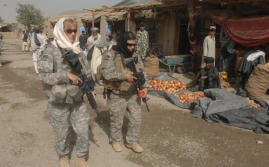 Female Engagement Team members Pfc. Rachel Miller, 39, of Northumberland, Pa., and Sgt. Richelle Aus, 25, of Michigan City, Ind., patrol through a bazaar in Zabul province, Afghanistan.