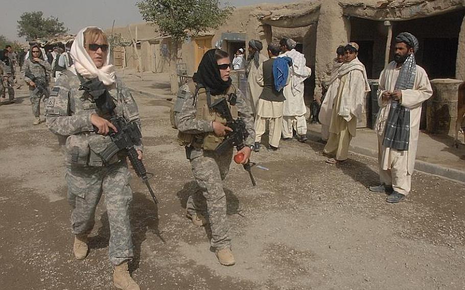 Female Engagement Team members Pfc. Kelly Shutka, 22, of Pine Glen, Pa., Pfc. Rachel Miller, 39, of Northumberland, Pa., and Sgt. Richelle Aus, 25, of Michigan City, Ind., patrol through a bazaar in Zabul province, Afghanistan.