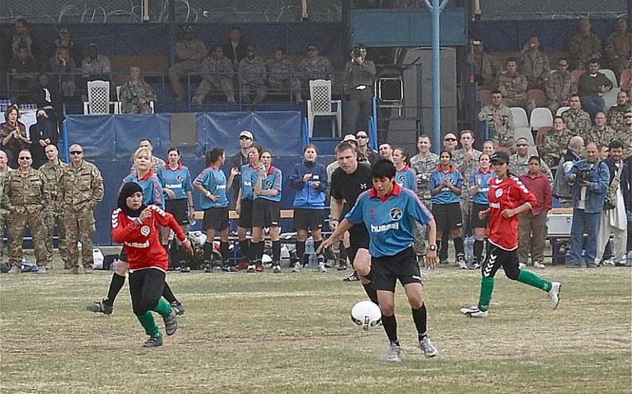 ISAF women's soccer team captain Danielle Figueroa controls the ball during a friendly match against the Afghan national women's soccer team at ISAF Headquarters in Kabul on Friday.