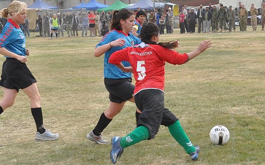 Afghan and ISAF women soccer players square off during a friendly match between the Afghan national women's soccer team and the ISAF women's team at ISAF Headquarters on Friday in Kabul.