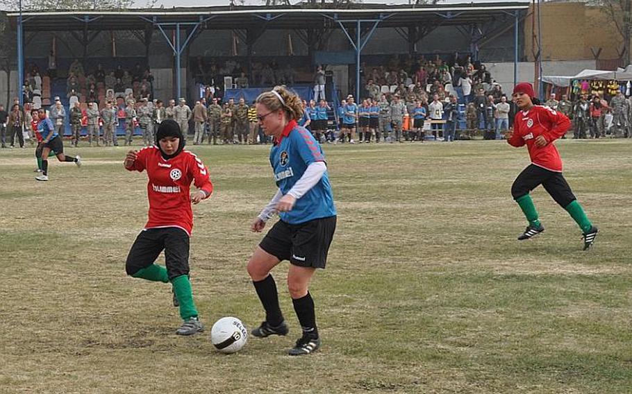 Afghan and ISAF women soccer players square off during a friendly match between the Afghan national women's soccer team and the ISAF women's team at ISAF Headquarters on Friday in Kabul.