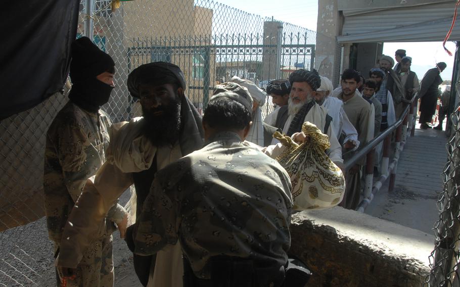 People cross from Pakistan into Afghanistan at the town of Wesh in Kandahar Province on Sept. 22.