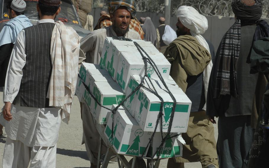 A man carries boxes across the border a wheelbarrow in Spin Boldak district, Afghanistan on Sept. 22.