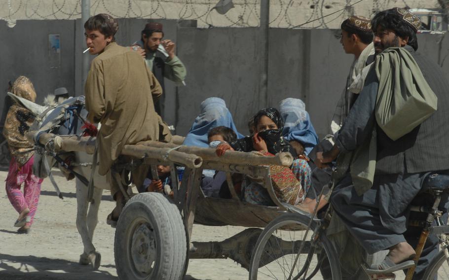 People cross from Pakistan into Spin Boldak district, Afghanistan using horses and carts and bicycles on Sept. 22.