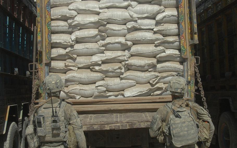 2nd Stryker Cavalry Regiment soldiers prepare to search trucks for bomb making chemicals near the Pakistani border in Spin Boldak district, Afghanistan on Sept. 22.