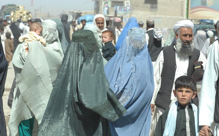 Burqa-clad women were amongst the crowds crossing from Pakistan into Spin Boldak district, Afghanistan on Sept. 22. U.S. soldiers there suspect some Taliban fighters may make the crossing disguised as women.